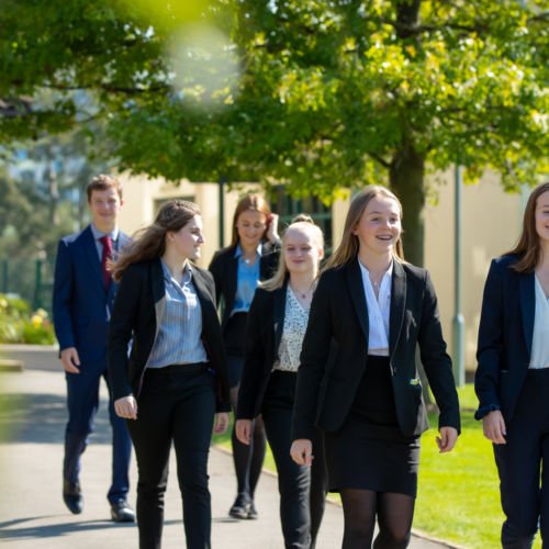 Wycliffe sixth form uniform pupils outside walking