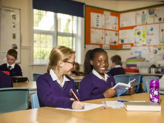 wycliffe girls smiling and reading in class